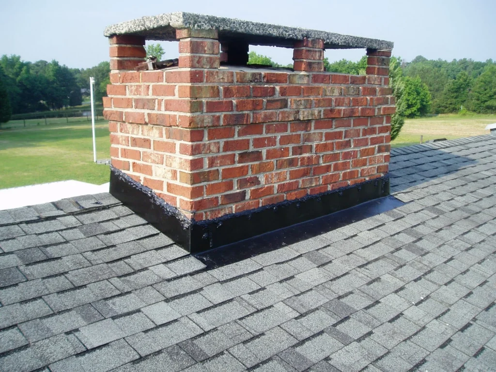 White efflorescence staining on a brick chimney